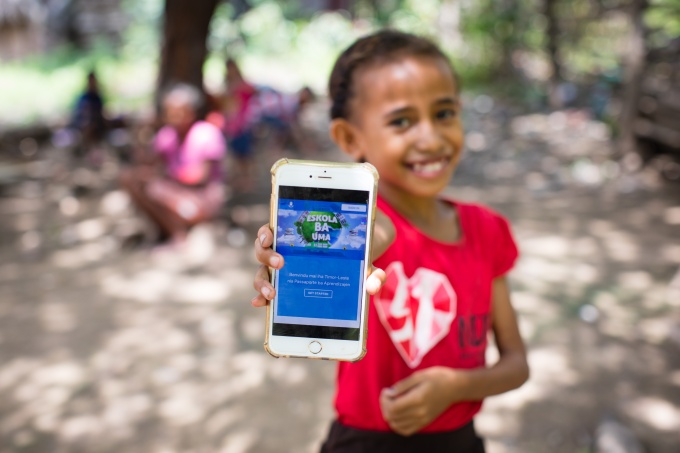  On April 14, 2020, a girl shows off the online platform on which children and parents in Timor-Leste can access a range of audio-visual material to help students continue learning during ongoing school closures. Television programs, radio programs and e-books, as well as a book for parents to explain COVID-19 to children with neurodevelopmental needs, are available on the Learning Passport platform developed by Microsoft, UNICEF and the University of Cambridge. Schools in Timor-Leste have been closed since March 23, 2020 as part of national efforts to prevent the spread of COVID-19. Credit: © UNICEF/UNI320751/Soares